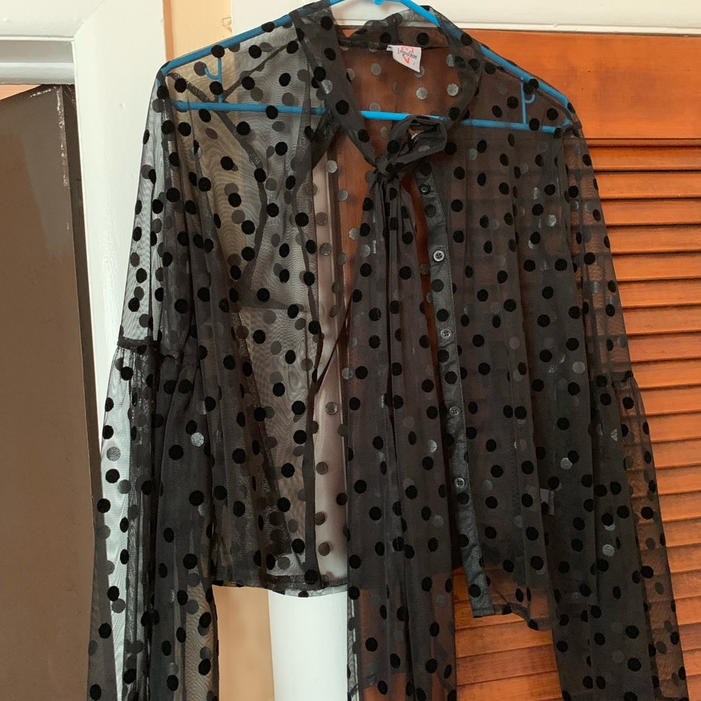 Sheer black polka dot blouse.